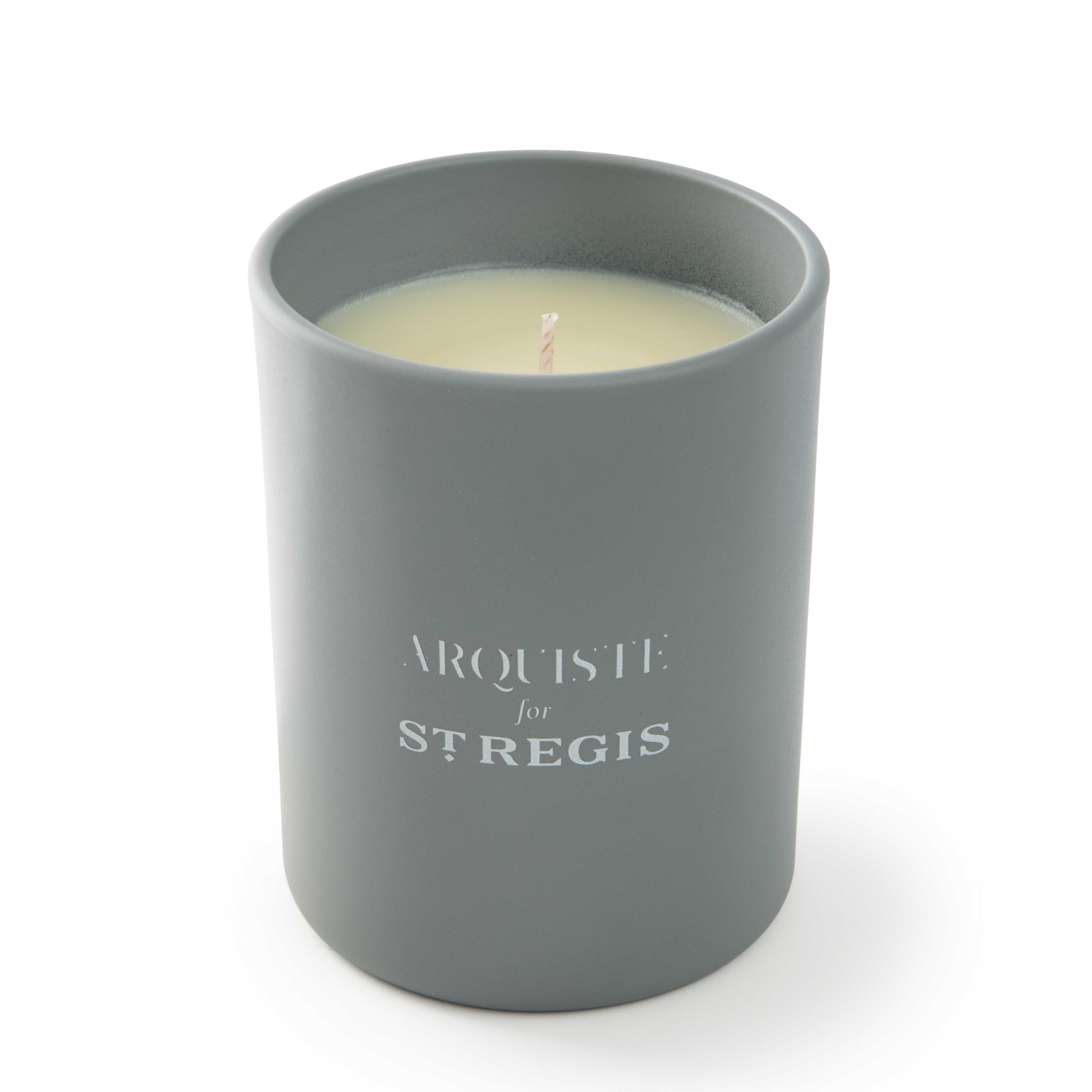 Gray candle in a container with 'Arquiste for St. Regis' branding on a white background