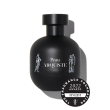 Load image into Gallery viewer, Black perfume bottle with &#39;Peau Arquiste&#39; branding and a &#39;2022 Fragrance Foundation Awards Finalist&#39; badge on a white background.