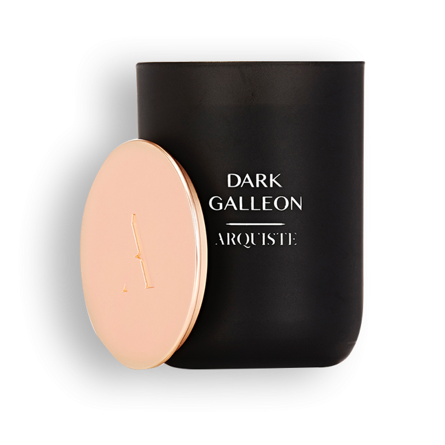 Black candle with a rose gold lid with Dark Galleon Arquiste branding on a white background