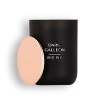 Load image into Gallery viewer, Black candle with a rose gold lid with Dark Galleon Arquiste branding on a white background
