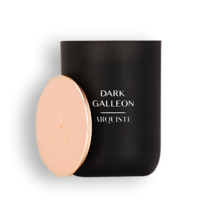 Black candle with a rose gold lid with Dark Galleon Arquiste branding on a white background