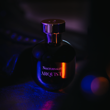 Load image into Gallery viewer, Perfume bottle with &#39;Nocturnality&#39; and &#39;Arquiste&#39; text in a dark setting