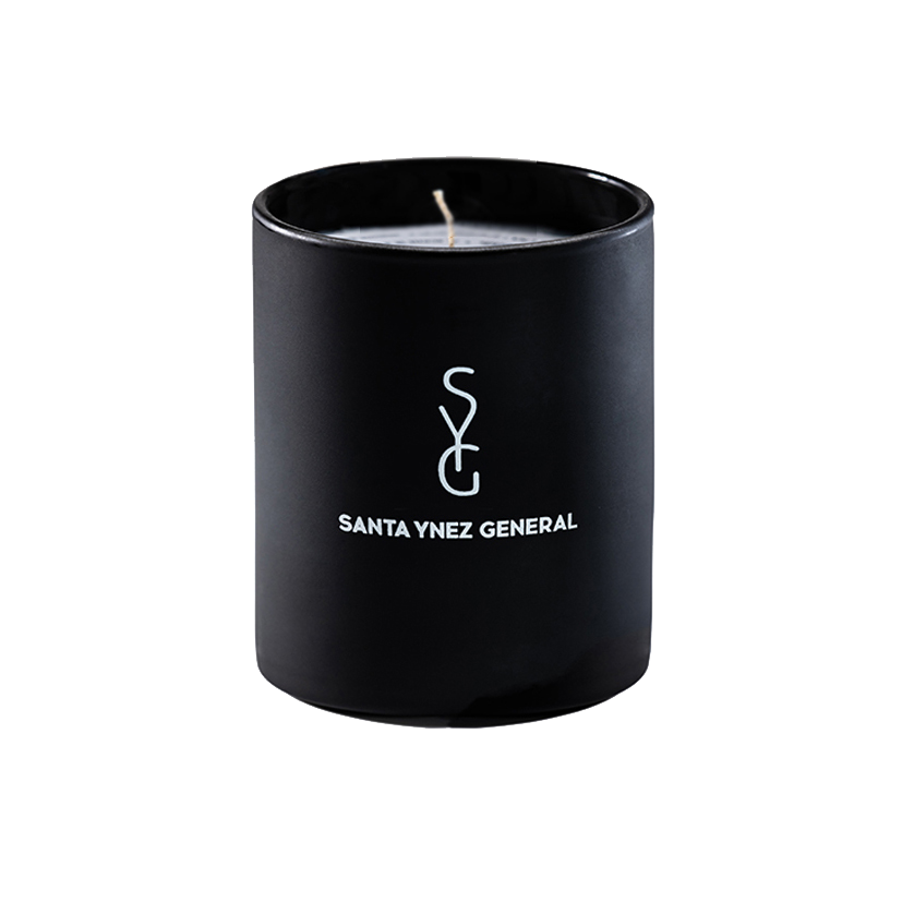 Black candle with 'Santa Ynez General' logo on a white background